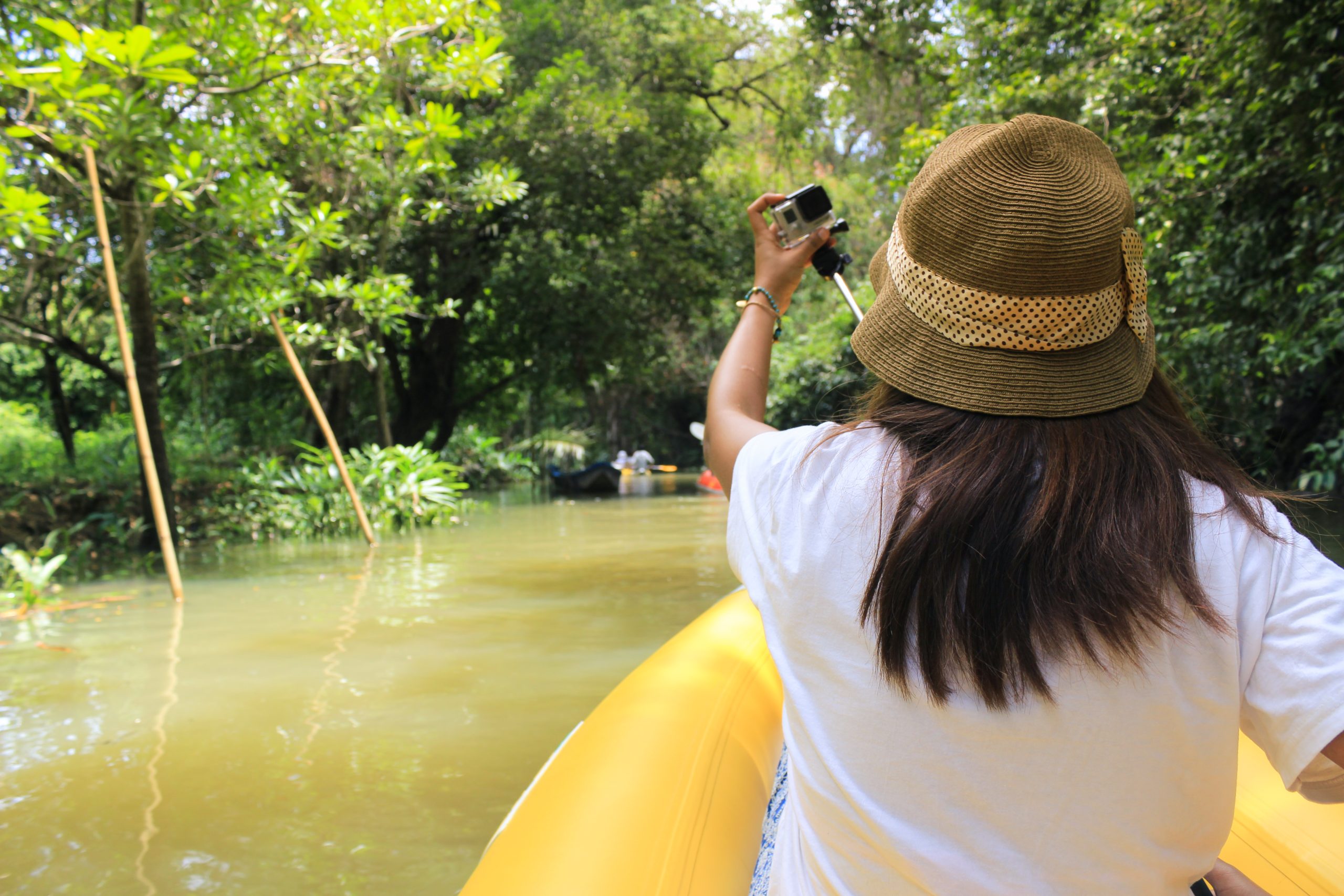 Woman kayaking along a beautiful tropical jungle river in gokarna